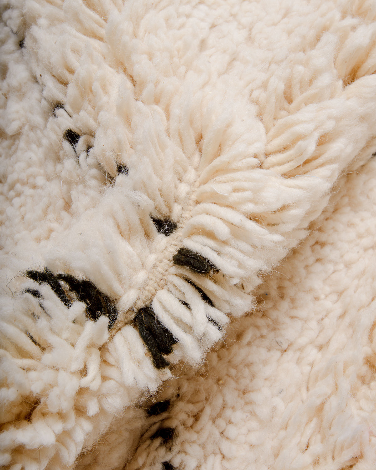 Detail of wool of cream and black Berber rug.